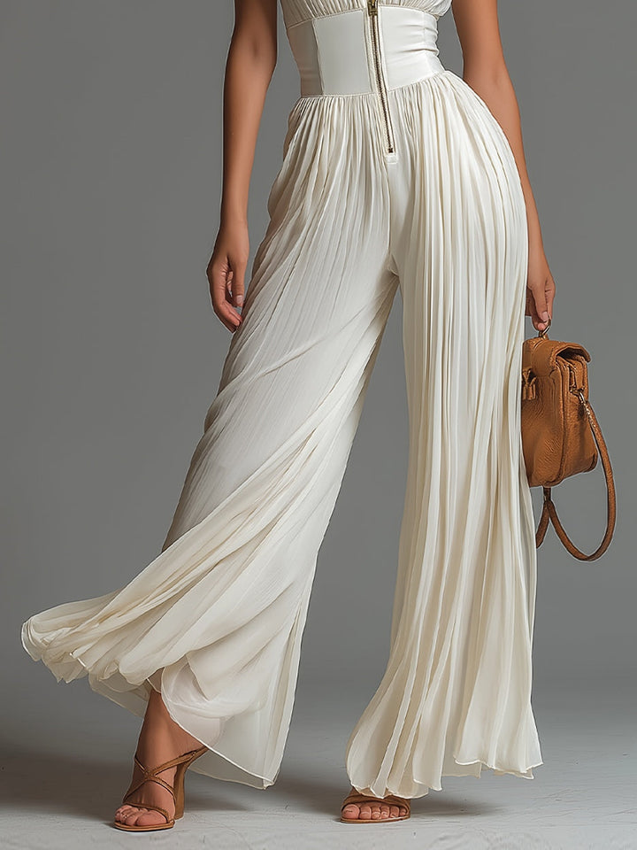 Witte mouwloze V-hals jumpsuit van chiffon met wijde pijpen, plooien en ritssluiting